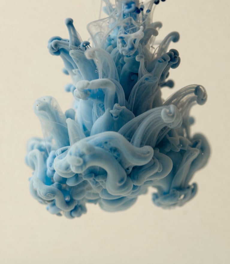 Macro photograph of soft blue ink swirling in warm cream water, diffused daylight, shallow depth of field, minimalist abstract style.