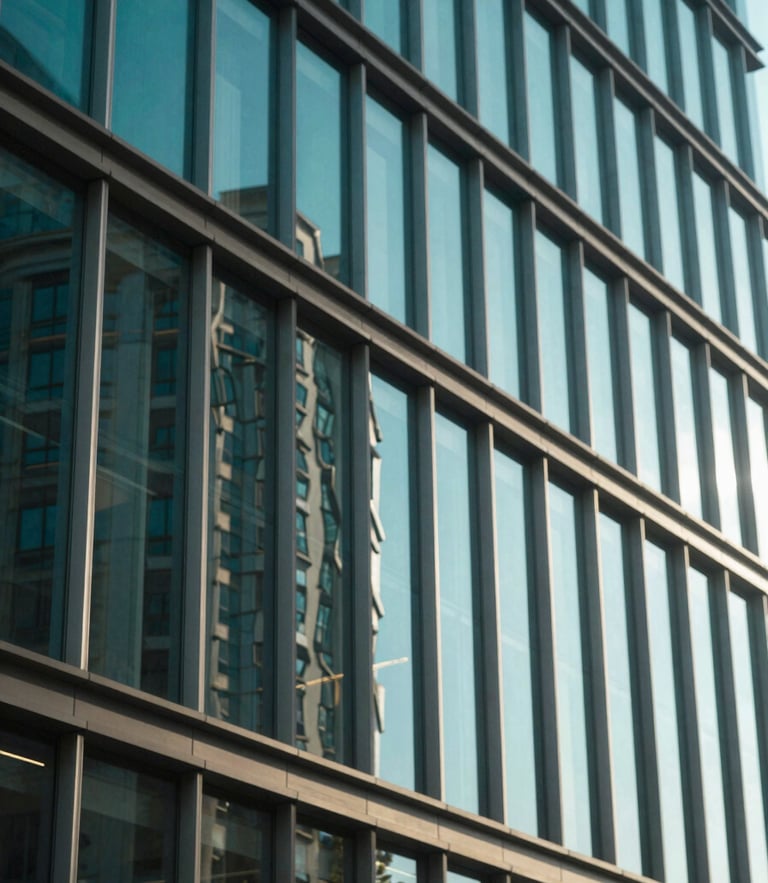 Modern glass office building facade reflecting bright natural sunlight, architectural perspective, deep teal tones, editorial corporate style, shallow depth of field, 35mm
