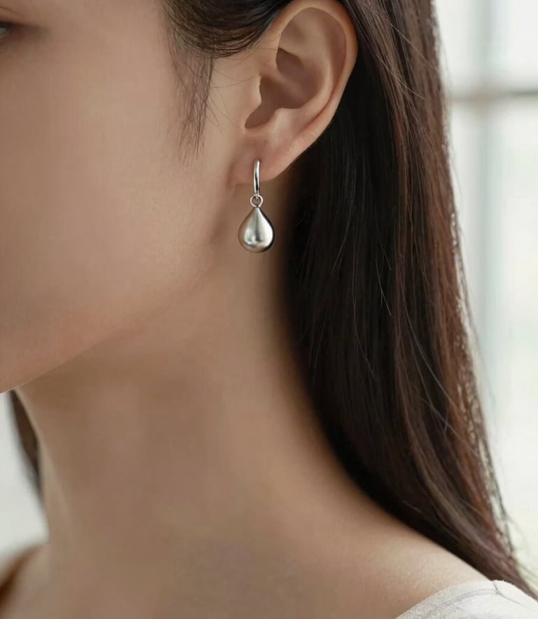 Macro portrait of an elegant woman wearing delicate silver earrings, soft natural window light, warm silver and sophisticated brown tones, shallow depth of field, macro lens, 35mm