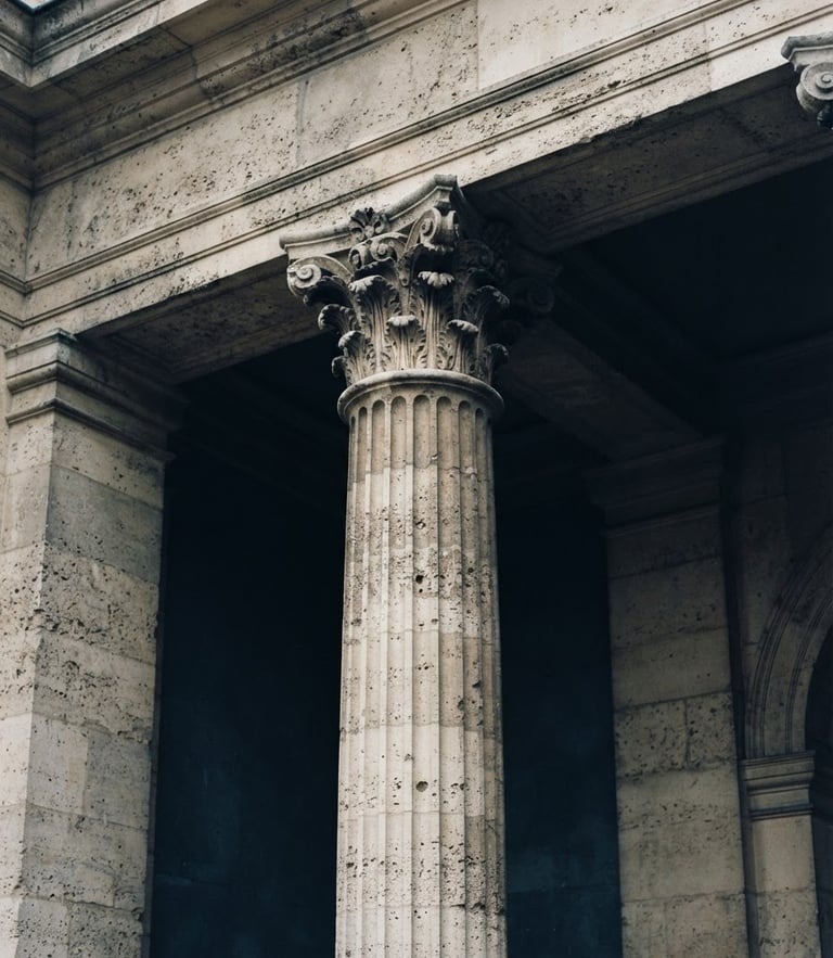 Close-up of a classic stone facade with architectural columns, soft overcast daylight, deep navy shadows, timeless editorial photography, 35mm film style