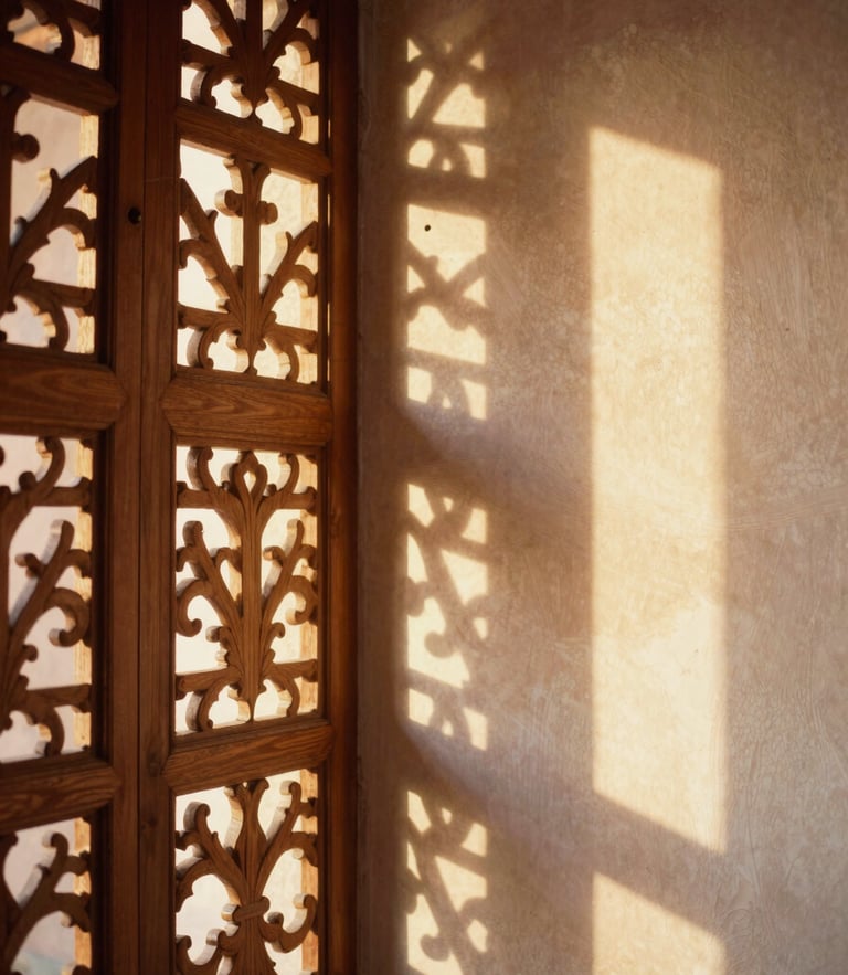 Soft golden-hour light filtering through a carved cedarwood screen, casting warm geometric shadows on a tadelakt plaster wall, 35mm editorial photography.