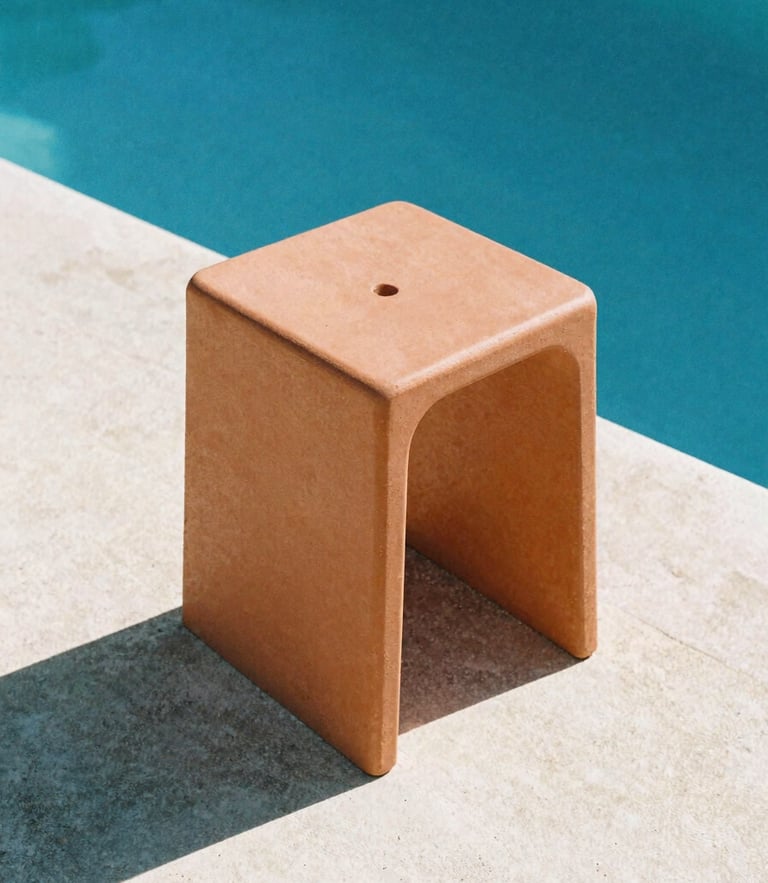 Low-angle architectural shot of a terracotta Monobloc stool on sun-drenched concrete by a deep blue pool, sharp midday shadows, matte polymer texture, 35mm film