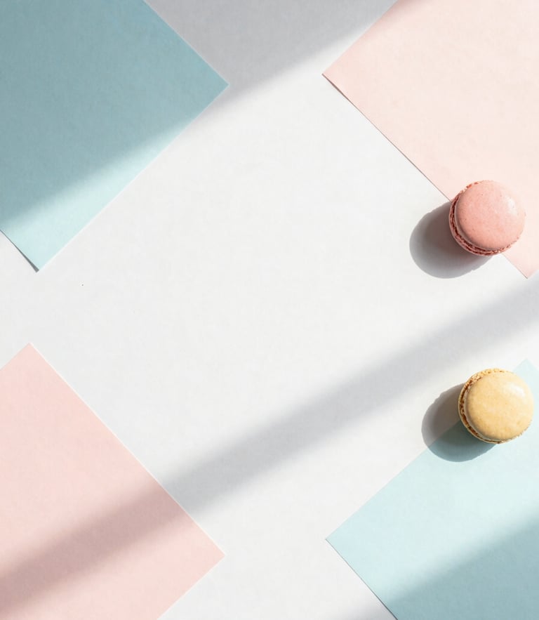 Minimalist abstract flat-lay of geometric pastel paper shapes casting soft morning shadows on a clean white desk, 35mm lens