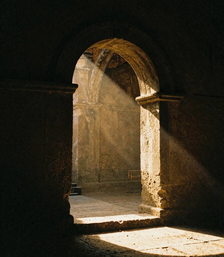 Chiaroscuro film photography of a solitary stone archway in a dark, ancient ruin, a single beam of dramatic golden sunlight piercing the gloom, 35mm grain.