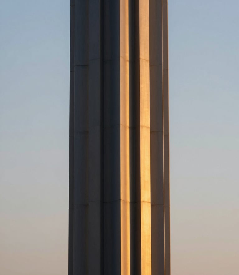 A close-up of premium warm gold metal finishes on a dark navy architectural column, soft twilight glow, medium format lens, editorial architectural photography