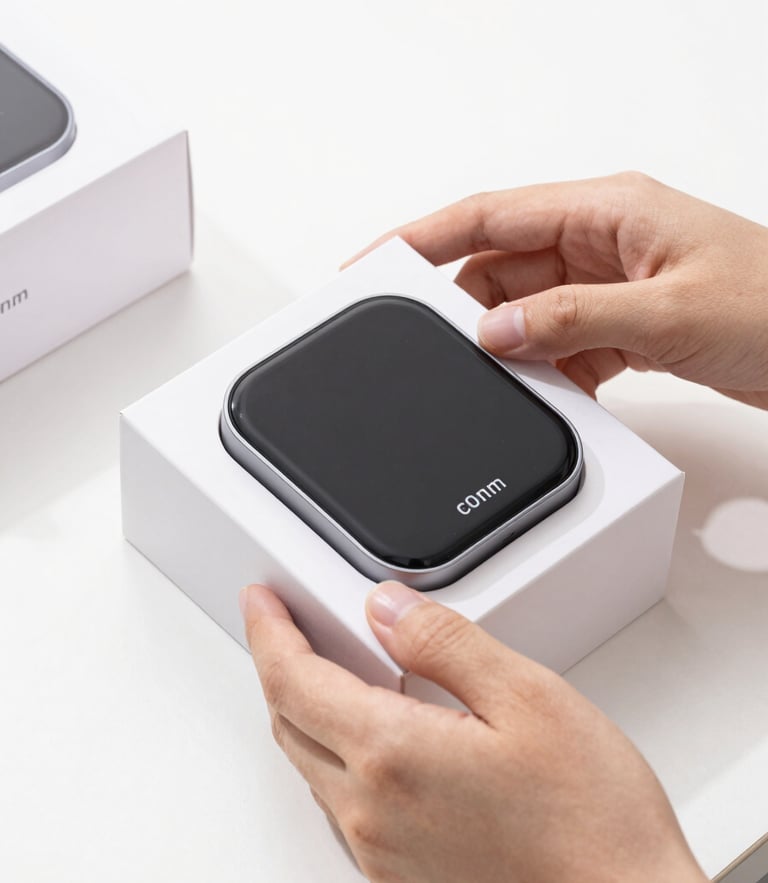 Bright high-key product photography of a modern smart gadget being unboxed by hands in a clean minimalist studio setting, crisp natural light, sharp focus