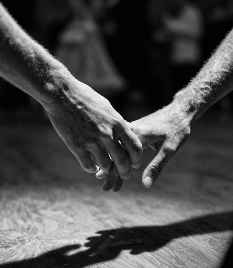 Low angle dramatic shot of hands connecting in ballroom dance, stark spotlight cutting through deep shadows, motion blur on the background, high contrast black and white.
