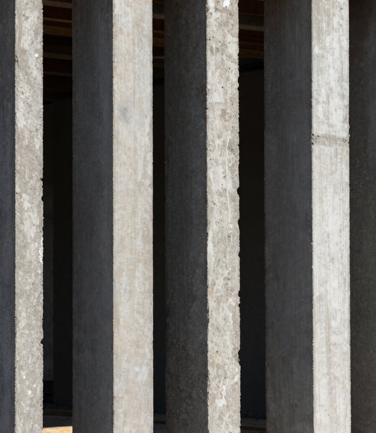 Vertical architectural framing, close-up of raw EPS monolithic panels integrated with concrete on a construction site, sharp geometry, dramatic natural light with high-contrast shadows