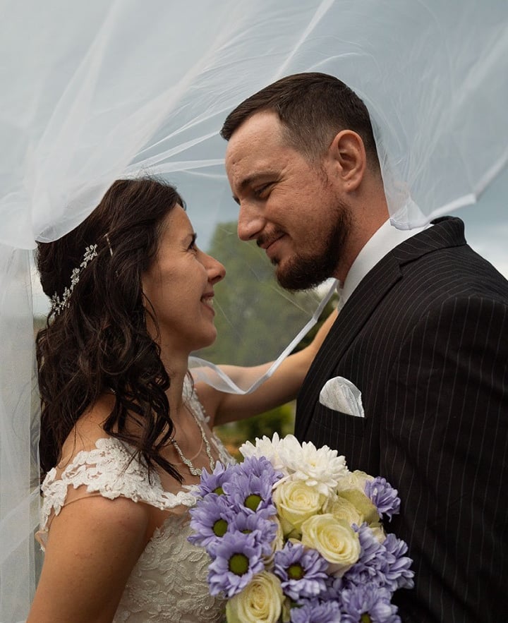 Bride and groom sharing a romantic moment during a wedding photoshoot in Preston Park, Brighton.