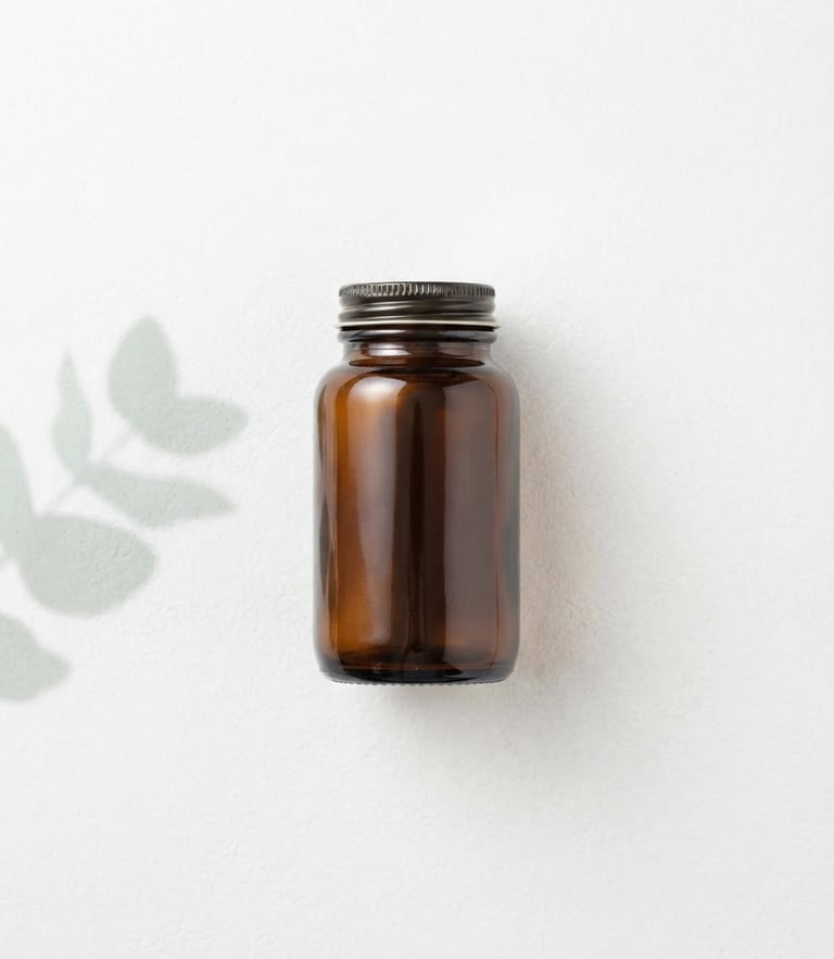 Overhead flat lay of single amber glass supplement bottle resting on a sterile white stone surface, clean studio lighting, soft mint green botanical leaf shadow