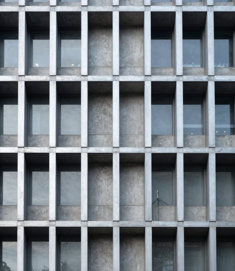 Symmetrical architectural detail of a modern concrete and steel building facade, high contrast, cool metallic silver tones, clean linear grid.