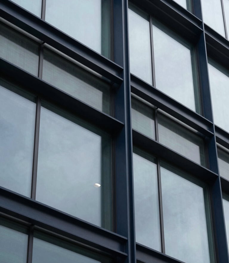 Extreme close-up of structured architectural steel and glass facade, overcast daylight, deep navy tones, sharp lines, 35mm