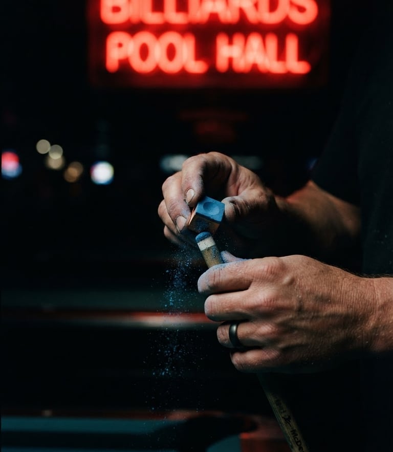 Moody low-key close-up of hands chalking a pool cue under a sharp red neon light, deep shadows, high-contrast editorial style