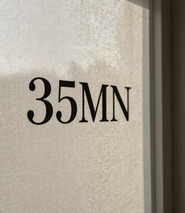 Close-up of textured linen canvas with stark black serif lettering, soft side-lighting from an overcast window, long afternoon shadows, 35mm
