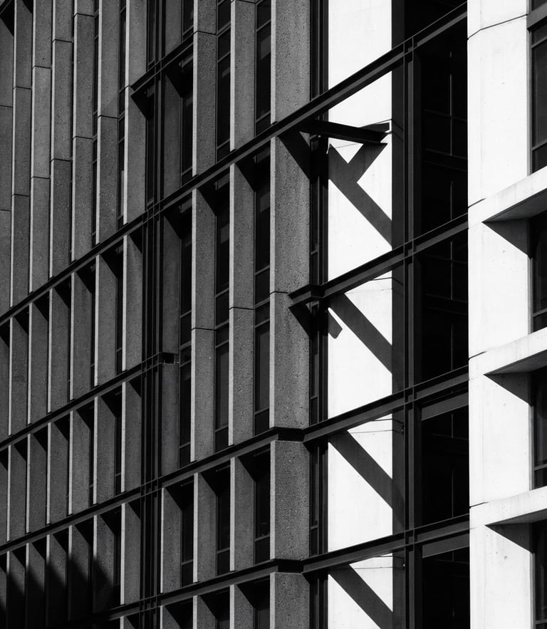 Minimalist architectural photography of a modern concrete and steel corporate headquarters facade, sharp geometric shadows cast by harsh direct sunlight, high contrast charcoal and white tones, sharp focus, 35mm lens