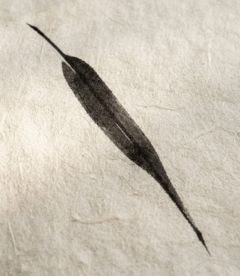 Minimalist fine art photography of a single black ink brush stroke depicting a bamboo leaf, soft natural side-light on textured warm off-white handmade paper, framed in simple light wood