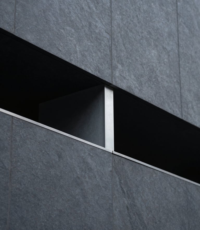 Sleek editorial photograph of modern structural geometry, dark slate and steel tones, cool diffused daylight, shallow depth of field, 35mm