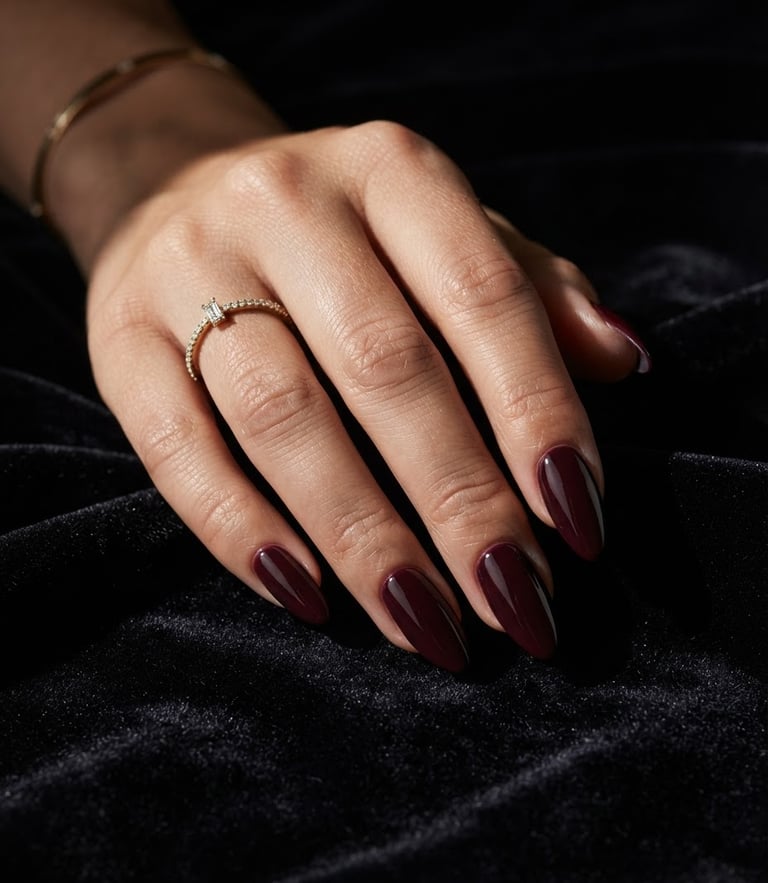 Macro editorial close-up of a hand with long, sculpted luxury nails resting on a dark velvet surface, dramatic side lighting highlighting the glossy gel texture, high-contrast shadows.