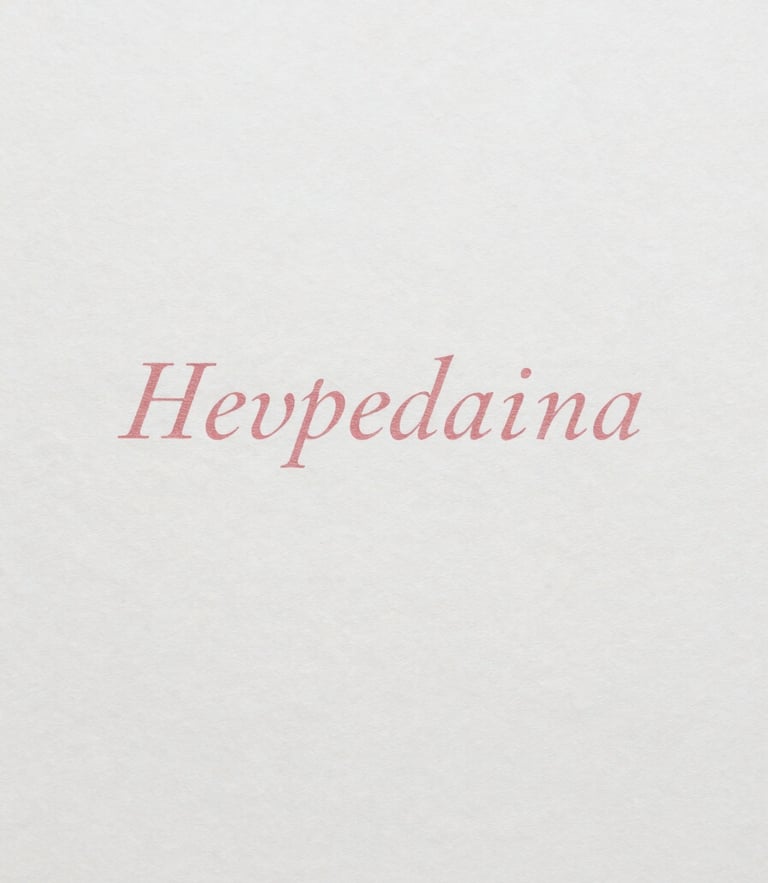 Overhead flat-lay of heavy-weight cotton paper stock with elegant printed serif typography, soft natural daylight, minimalist aesthetic.