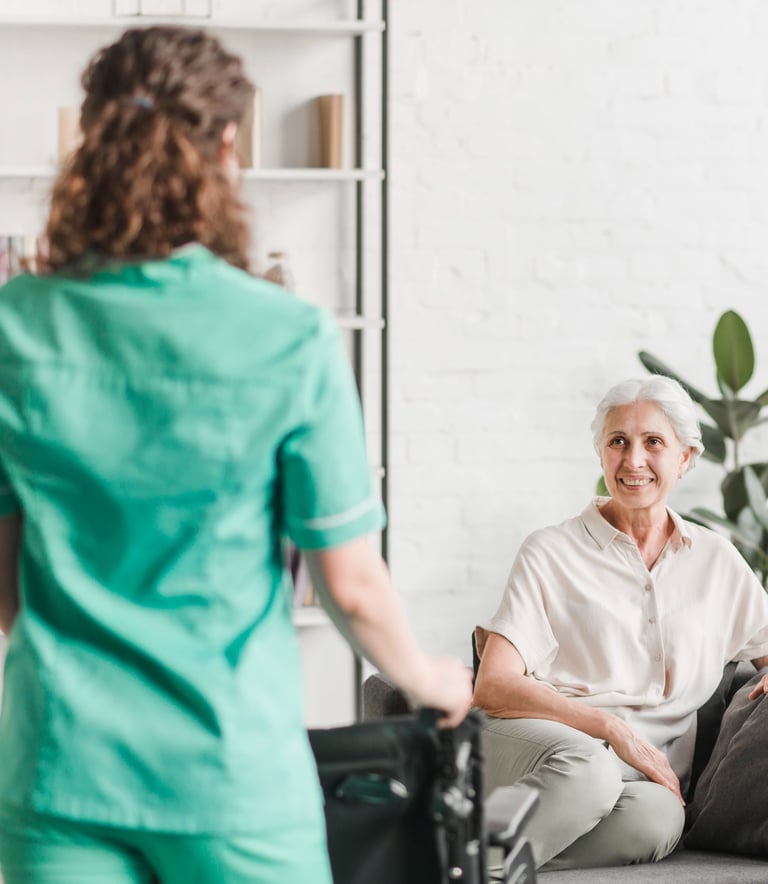 a caregiver and a senior woman in a living room