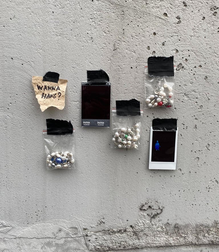 fun.arc.ik. necklaces in zip-lock bags on a concrete wall product picture
