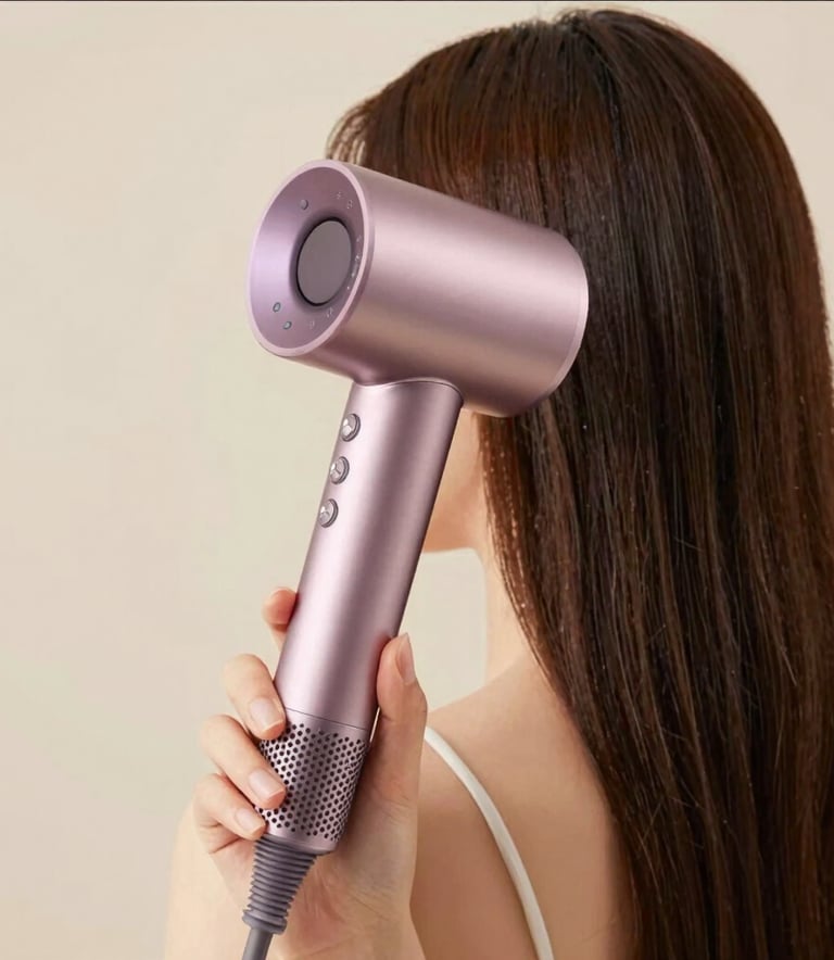 Close-up of elegant beauty tools like brushes and sponges resting on a smooth marble surface with warm, natural light