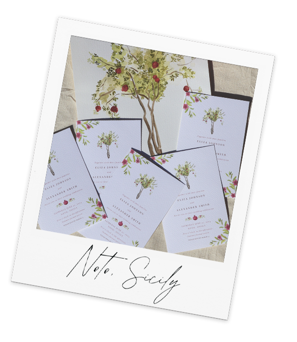 a bunch of wedding invitations with a pomegranate tree in the background