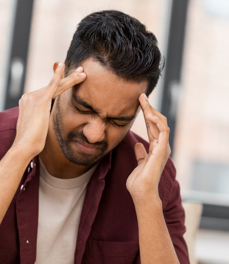 Frustrated man holding his head with both hands, feeling stressed and too busy for cleaning.