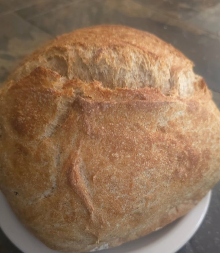 Heritage whole wheat sourdough boule with golden scored crust, baked fresh to order at Mandy's Mount