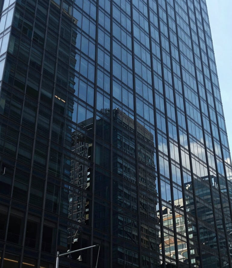 Wide shot of a modern glass office building in a business district in Mexico City, with deep navy blue glass reflections, symbolizing strength and corporate insurance expertise.
