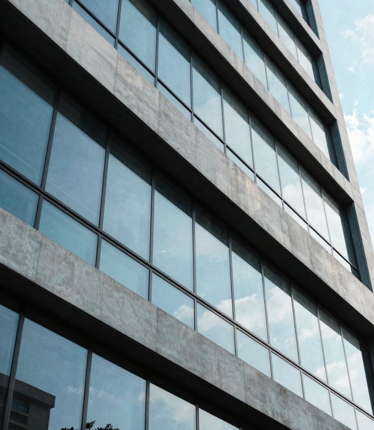 A professional photography shot of a modern architectural building in Jakarta with clean lines and large windows, reflecting a bright blue sky, conveying innovation and growth.