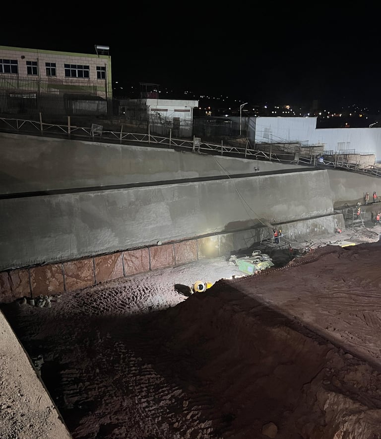 Hillside with soil nailing and geogrid reinforcement for slope stabilization.