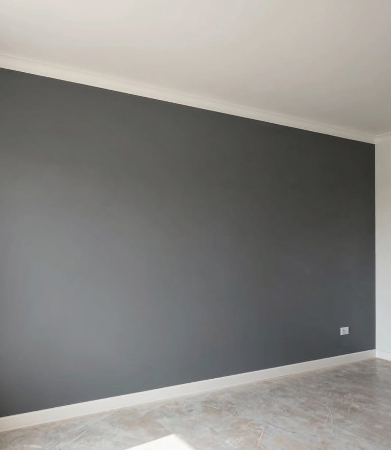 A wide-angle professional photograph of a freshly painted interior space in Ankara, showcasing a feature wall with a sophisticated charcoal grey texture next to a clean white-ish ceiling. The room is filled with soft natural light, highlighting the smooth, high-end finish and minimalist furniture in a Middle Eastern setting.
