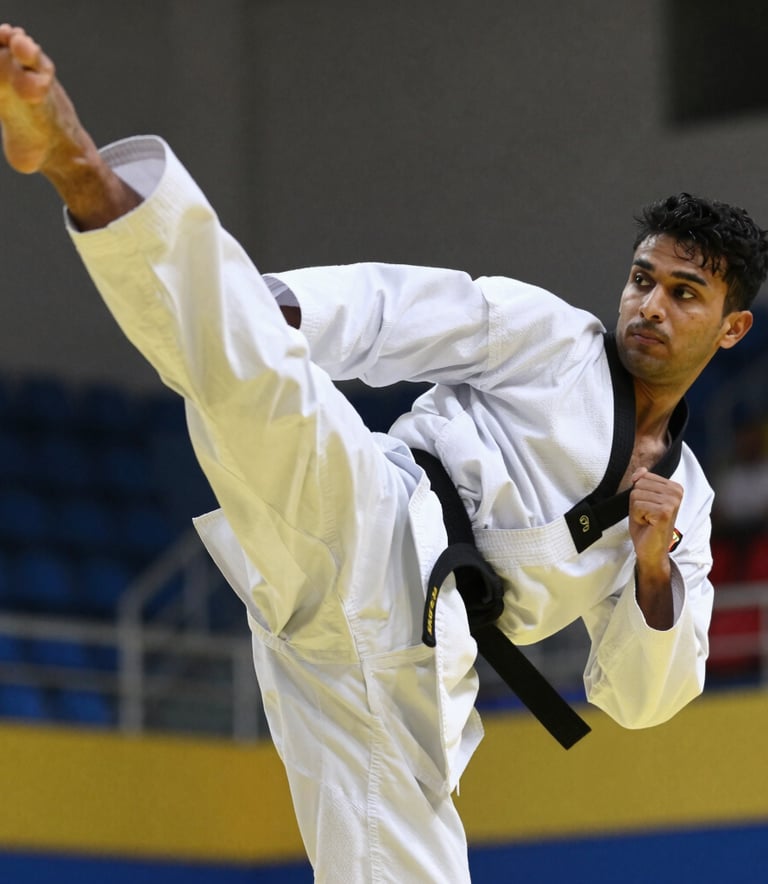 A close-up, high-action photograph of a South Asian martial artist's legs mid-air performing a powerful side kick. The athlete wears a clean white Taekwondo dobok with a prominent black belt. The background is a modern, slightly blurred sports hall with dark blue and yellow accents, focusing on the precision and intensity of the movement.