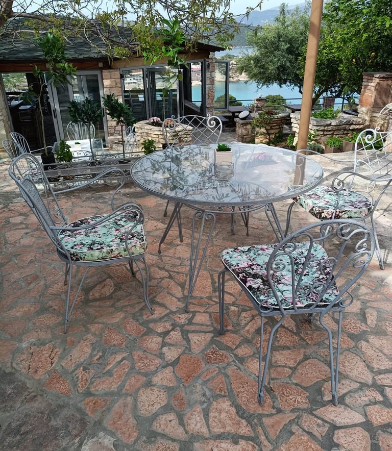 "Unwind in Style with a Meal at John's Guesthouse Tavern, Featuring Stunning Views of Ksamil's Bay!"