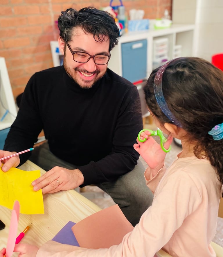 BCT Owner Constantinos Kokkinos providing expressive therapy in office at PlayWell Brooklyn