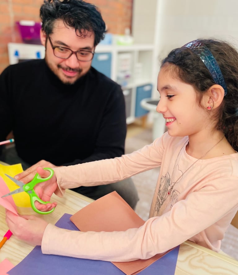 Owner Constantinos Kokkinos providing expressive therapy to a client at PlayWell Brooklyn