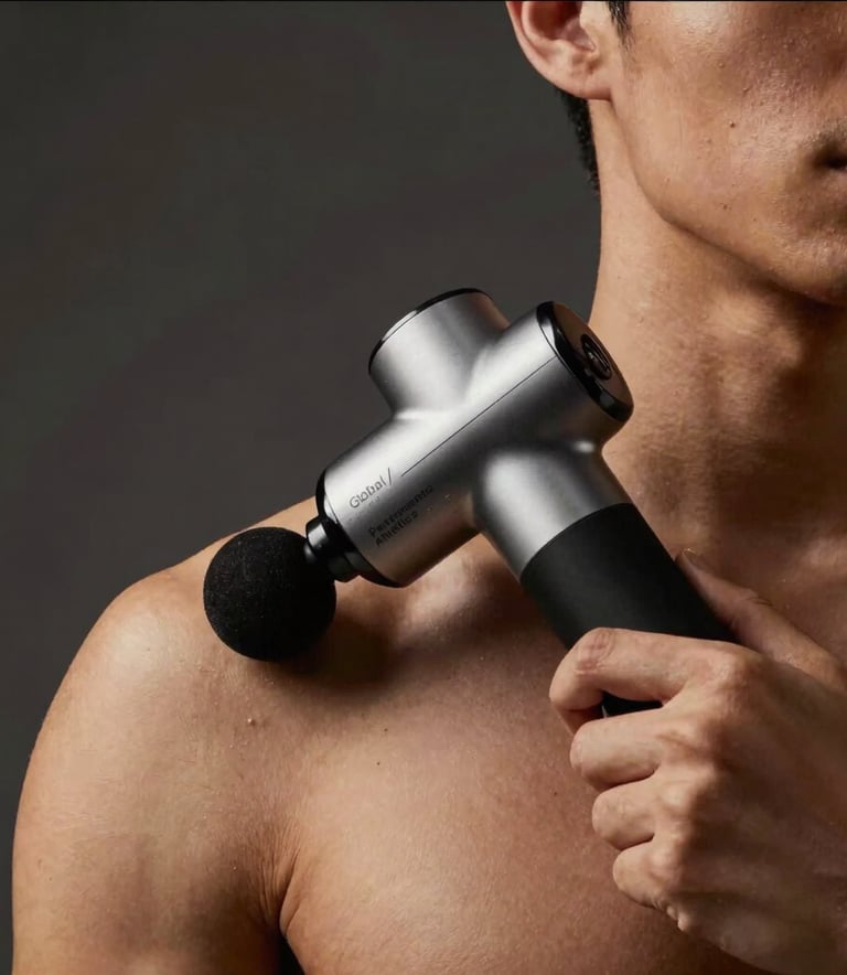 Cinematic photography of a male athlete's upper body from the chest up, using a premium recovery massage gun on his shoulder. Low-key lighting with Gold and Deep Black tones. Dark Charcoal studio setting, Global / Performance Athletics.