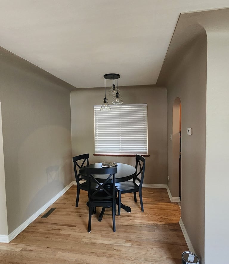 Residential interior painting in Denver featuring clean lines and neutral color palette in a dining 