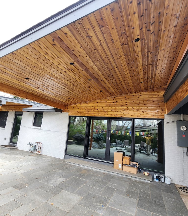 Professional exterior wood staining and soffit finishing for a modern Denver home patio