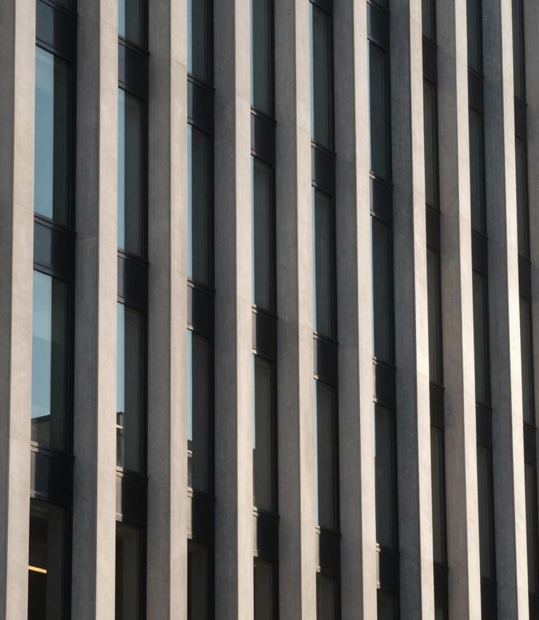 A close-up of a minimalist facade with clean vertical lines and glass windows, captured in the soft morning light of a North American urban environment, highlighting architectural precision in charcoal and off-white.