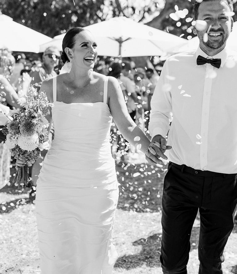 Newlyweds walk down the aisle at a Noosa beach wedding ceremony
