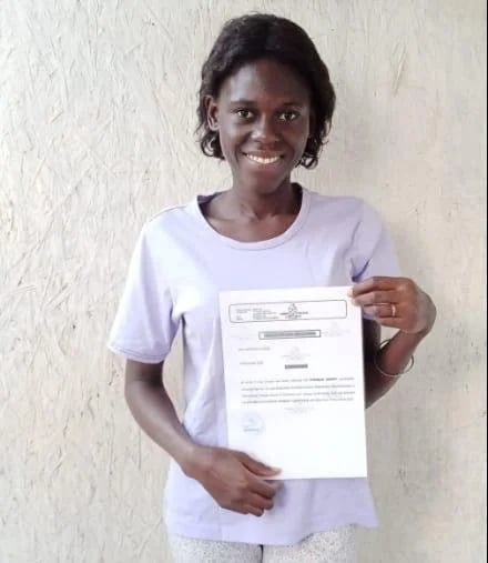 Therese, a Jump Finance student at Gambia College, holding her teacher attestation letter