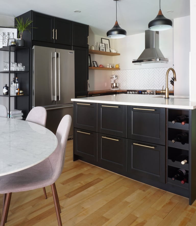 a black kitchen with a marble tulip table and chairs