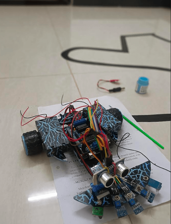 Final version of a DIY Arduino line-following robot with multiple IR sensors and an ultrasonic senso