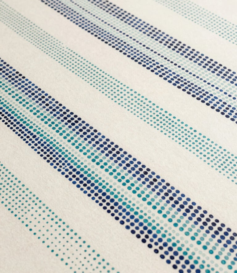 Close flatlay of a small pointillist panel, midnight blue and teal dots arranged in slow diagonal bands across ivory ground, diffuse studio light, sparse passages between bands leaving ground visible