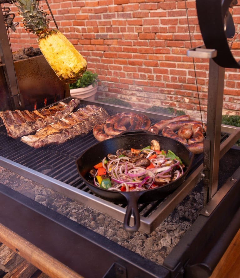 a variety of meats and vegetables cooking on a santa maria grill
