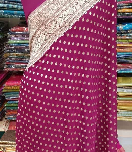 Maroon georgette saree showcasing fine floral threadwork and a lace-trimmed border
