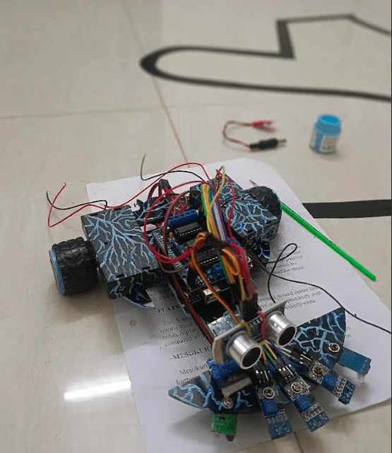 Final version of a DIY Arduino line-following robot with multiple IR sensors and an ultrasonic senso