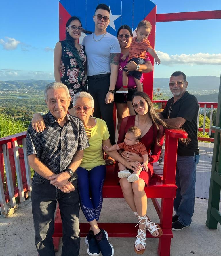 a family in a big decorative puerto rico shair